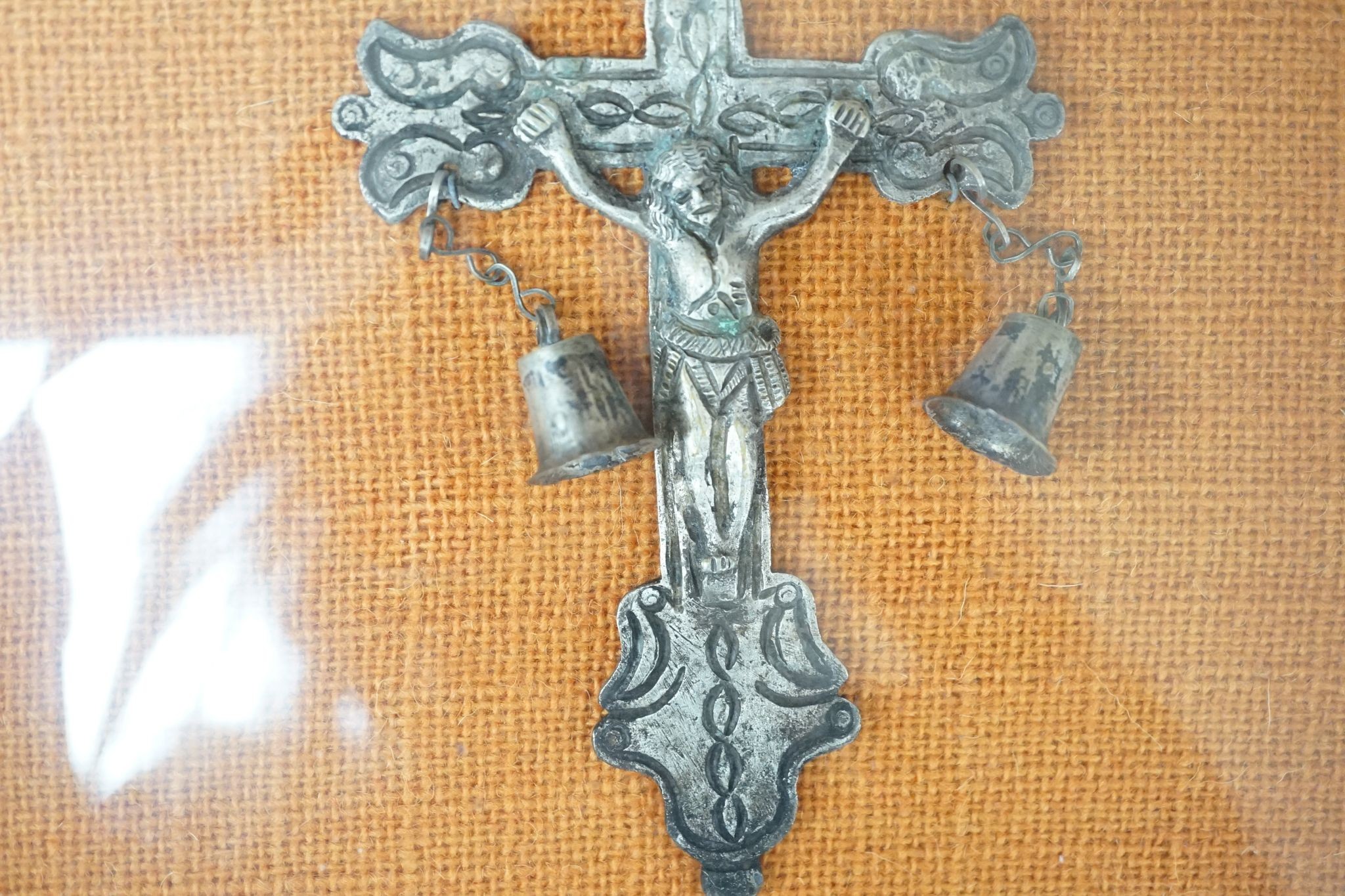 A carved crucifix and a framed metal Peruvian colonial crucifix, 50cm